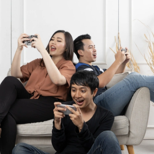 Family enjoying high-speed cable internet on laptop, tablet, and smartphone from their living room couch.
